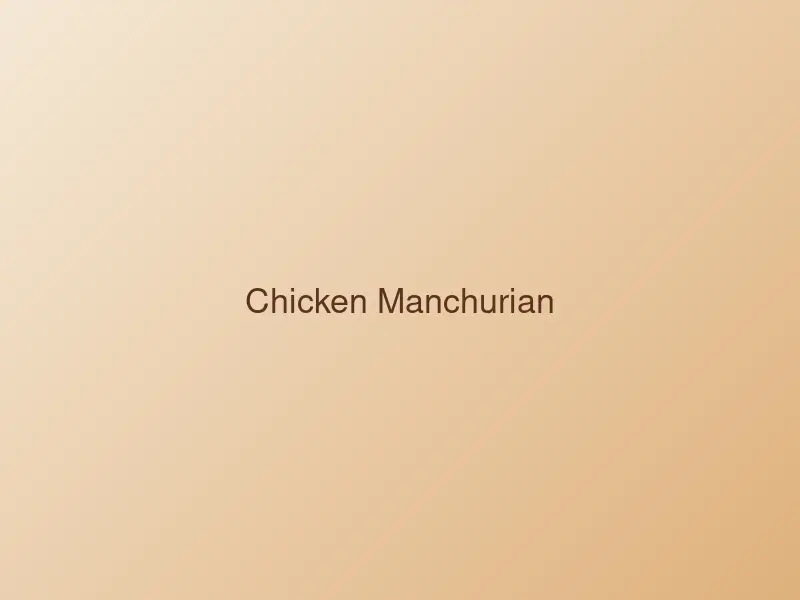 Chicken Manchurian in a glossy brown sauce with spring onion