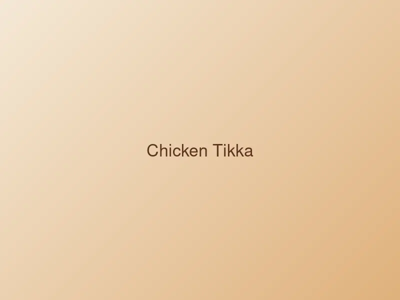 Char-grilled chicken tikka pieces garnished with onion and lemon