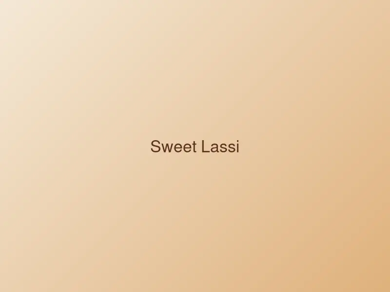 Glass of chilled sweet lassi topped with cream